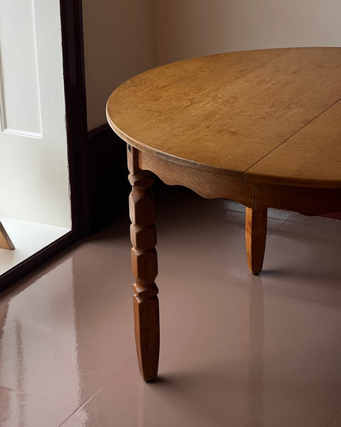 Vintage round wooden dining table with wavy/scalloped details