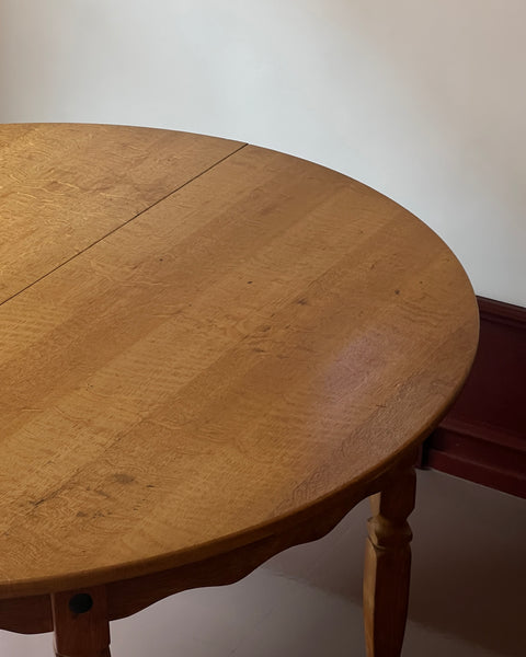 Vintage round wooden dining table with wavy/scalloped details