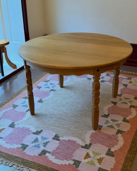 Vintage round wooden dining table with wavy/scalloped details
