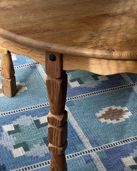 Vintage round wooden dining table with wavy/scalloped details