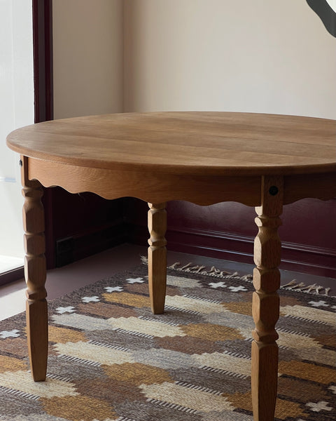 Vintage round wooden dining table with wavy/scalloped details