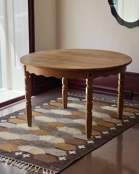 Vintage round wooden dining table with wavy/scalloped details
