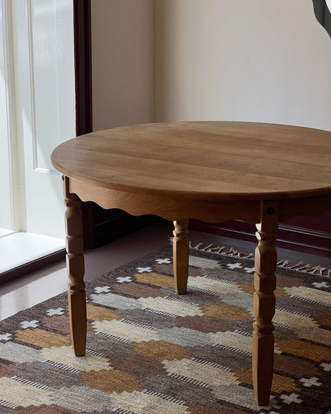 Vintage round wooden dining table with wavy/scalloped details