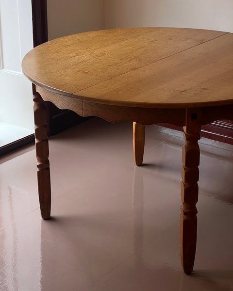 Vintage round wooden dining table with wavy/scalloped details
