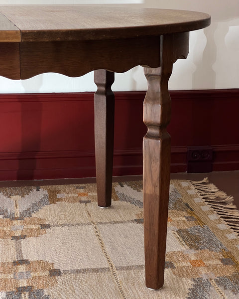 Vintage round wooden dining table with wavy/scalloped details