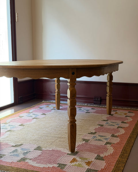Vintage round wooden dining table with wavy/scalloped details