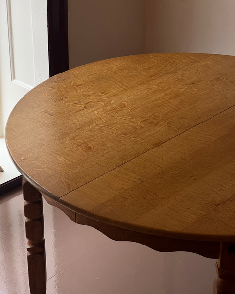 Vintage round wooden dining table with wavy/scalloped details