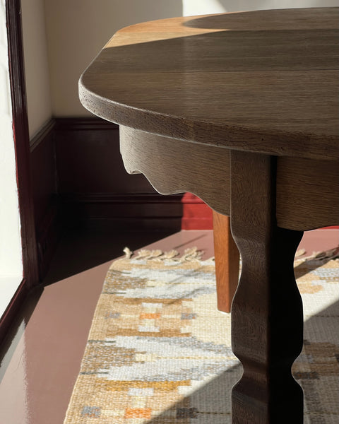Vintage round wooden dining table with wavy/scalloped details