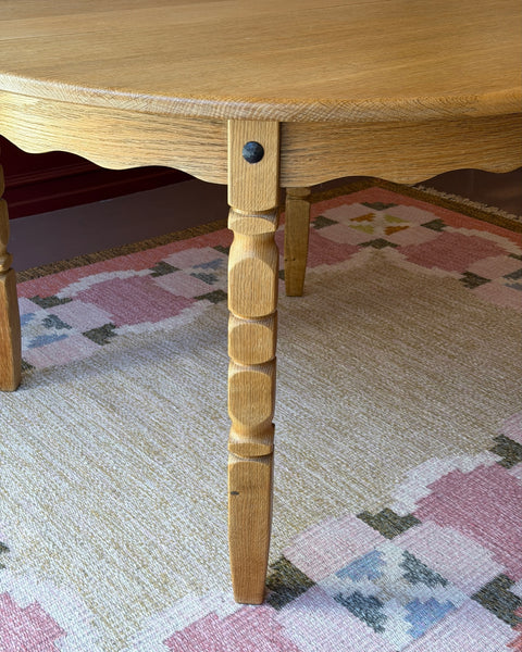 Vintage round wooden dining table with wavy/scalloped details