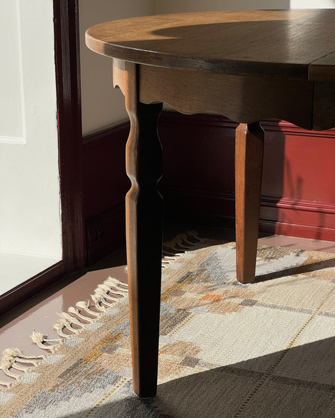 Vintage round wooden dining table with wavy/scalloped details
