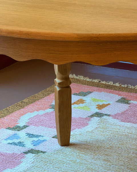 Vintage round wooden dining table with wavy/scalloped details