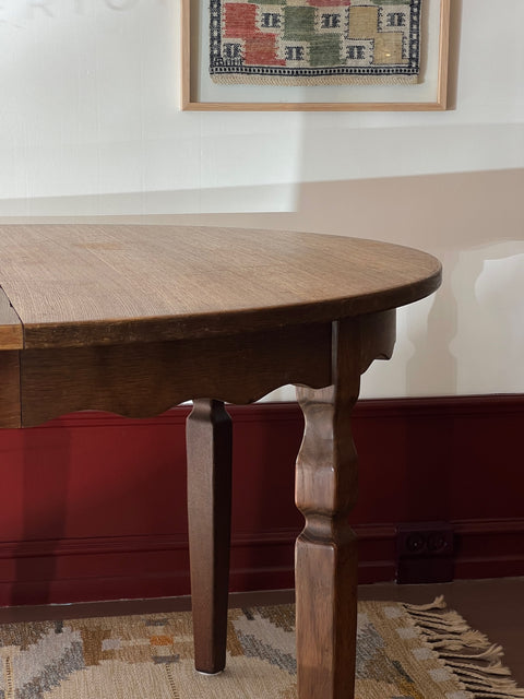 Vintage round wooden dining table with wavy/scalloped details