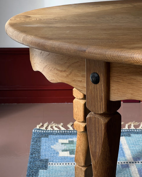 Vintage round wooden dining table with wavy/scalloped details