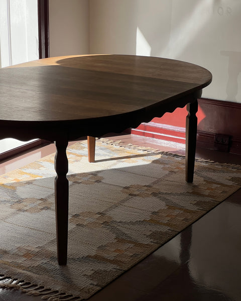 Vintage round wooden dining table with wavy/scalloped details
