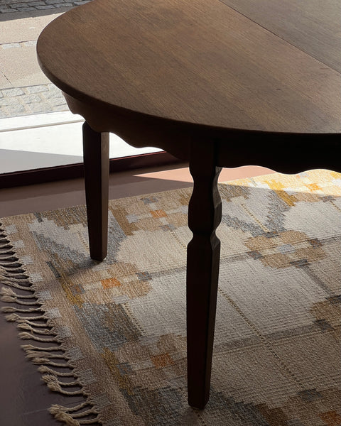 Vintage round wooden dining table with wavy/scalloped details