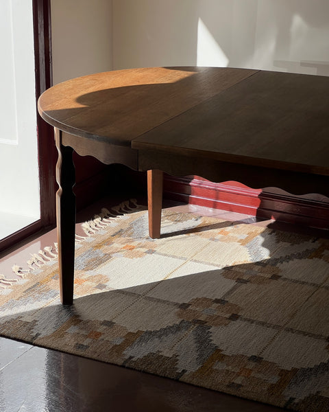 Vintage round wooden dining table with wavy/scalloped details
