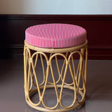 Rattan stool with striped cushion