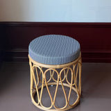 Rattan stool with striped cushion