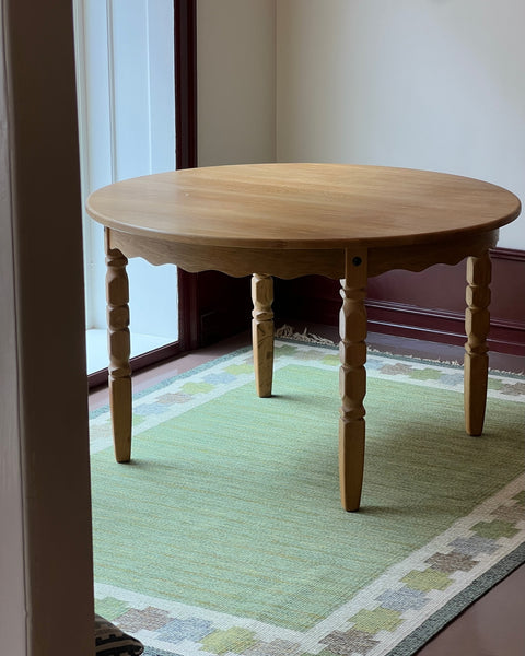 Vintage round wooden dining table with wavy/scalloped details