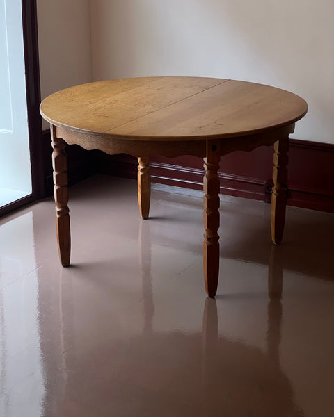 Vintage round wooden dining table with wavy/scalloped details