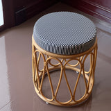 Rattan stool with striped cushion
