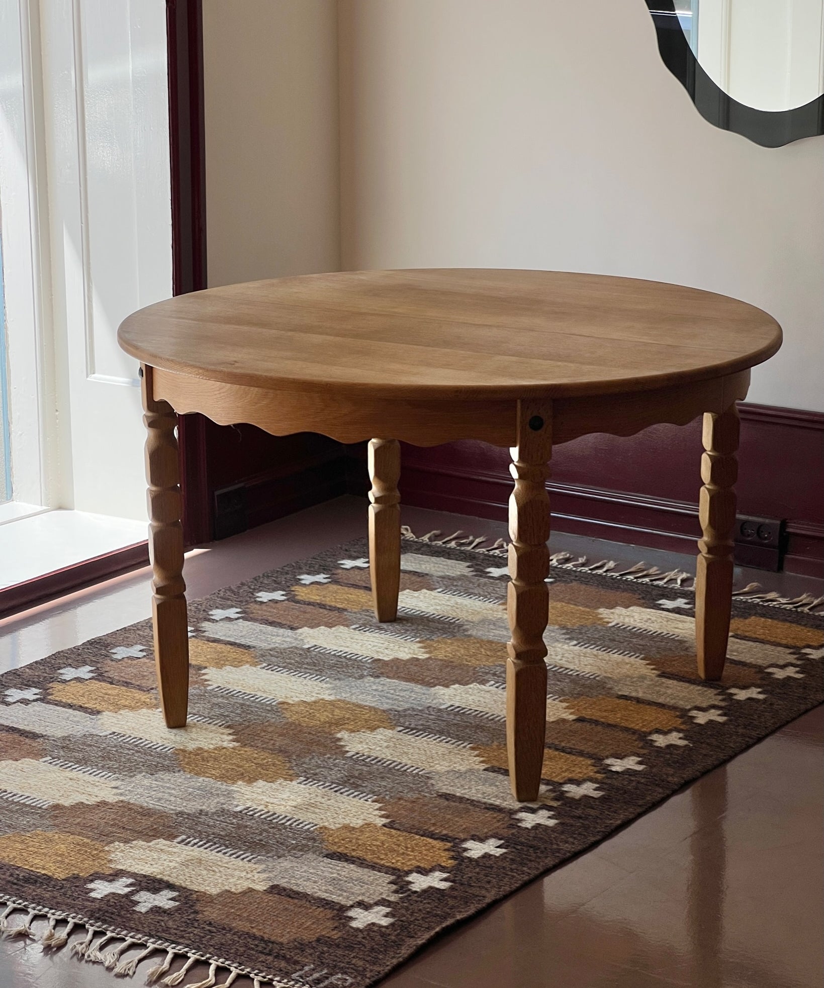 Vintage round wooden dining table with wavy/scalloped details