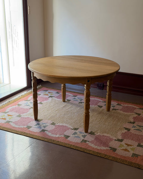 Vintage round wooden dining table with wavy/scalloped details