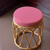 Rattan stool with striped cushion