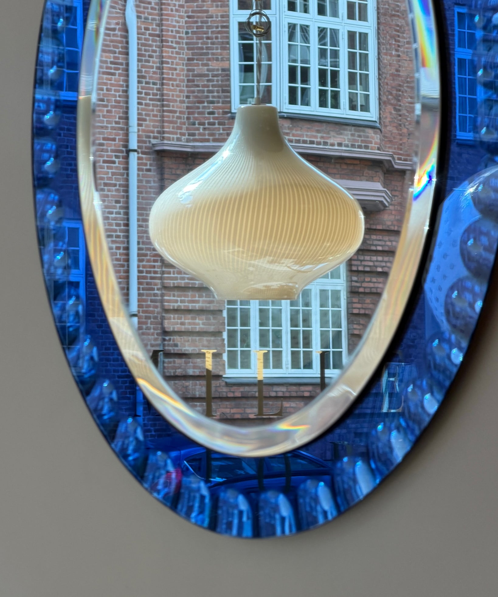 Vintage Italian mirror with faceted blue mirror frame