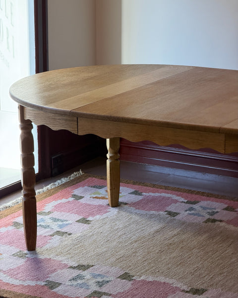 Vintage round wooden dining table with wavy/scalloped details