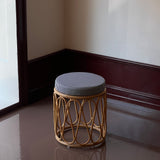 Rattan stool with striped cushion