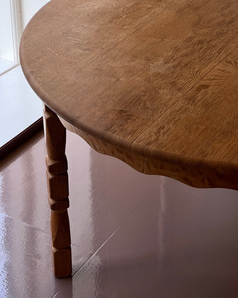 Vintage round wooden dining table with wavy/scalloped details