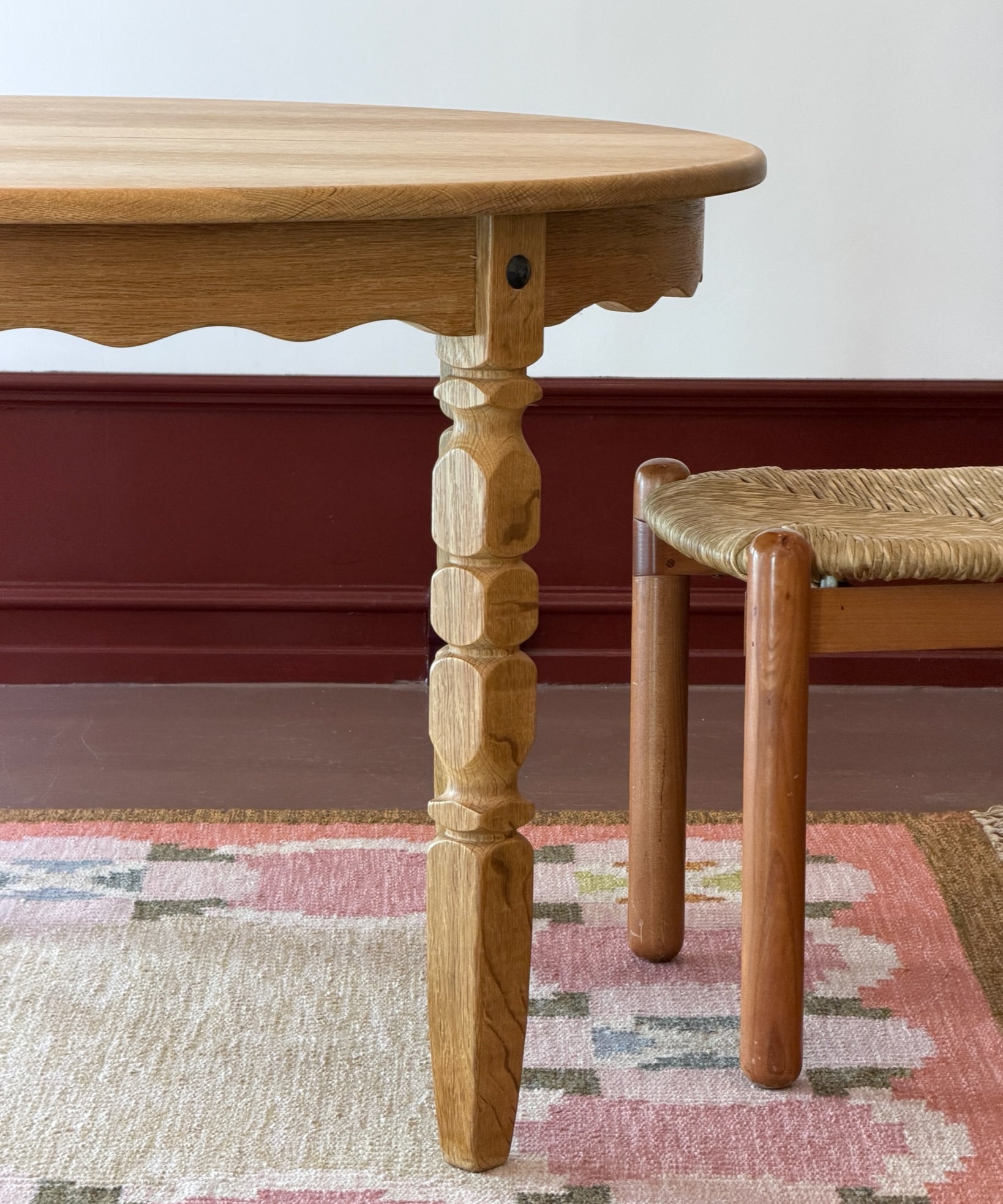 Vintage round wooden dining table with wavy/scalloped details