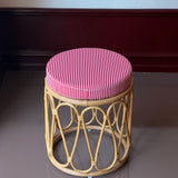 Rattan stool with striped cushion
