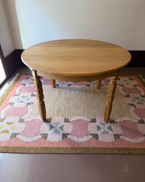 Vintage round wooden dining table with wavy/scalloped details