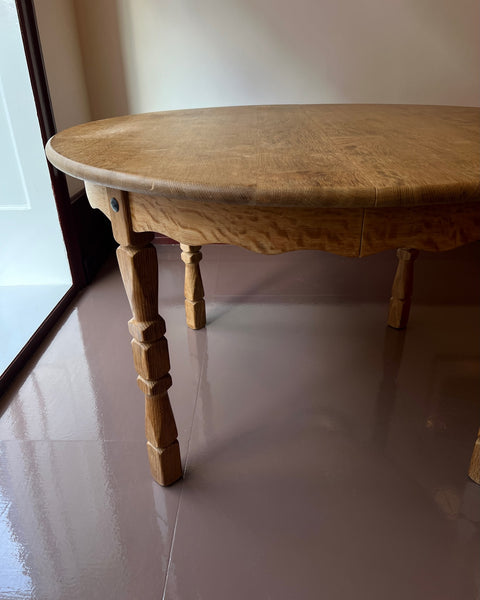 Vintage round wooden dining table with wavy/scalloped details