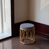 Rattan stool with striped cushion