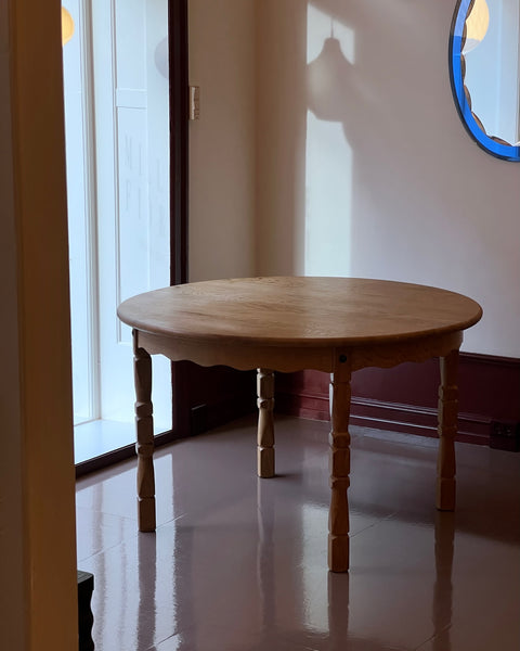 Vintage round wooden dining table with wavy/scalloped details