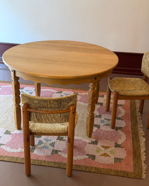Vintage round wooden dining table with wavy/scalloped details