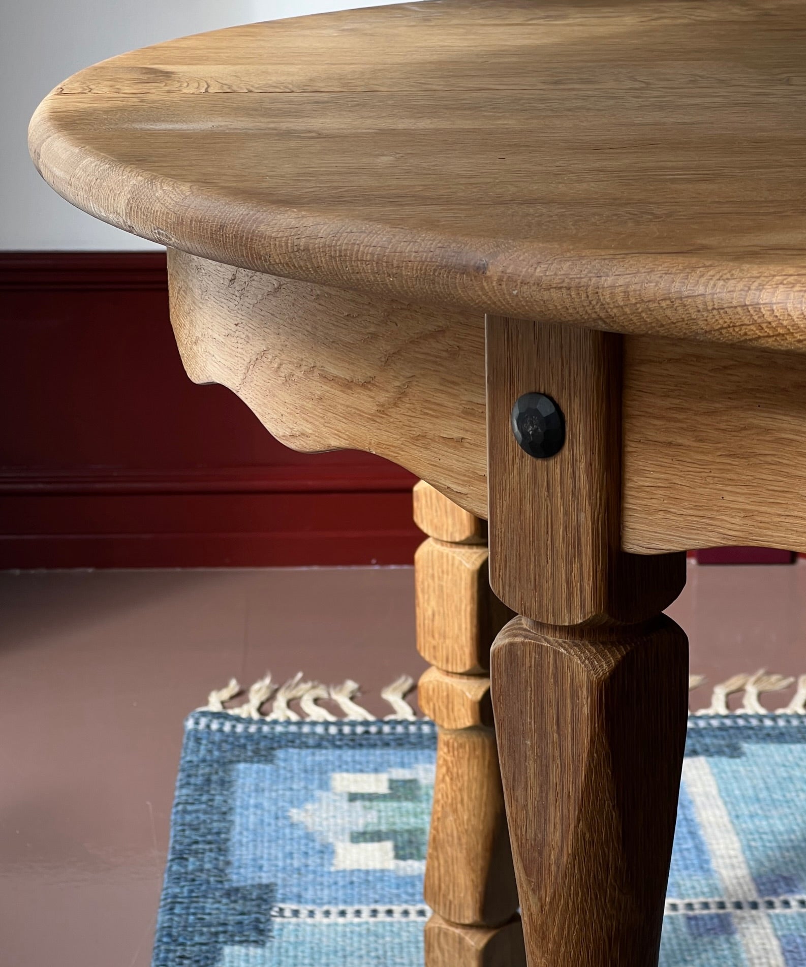 Vintage round wooden dining table with wavy/scalloped details