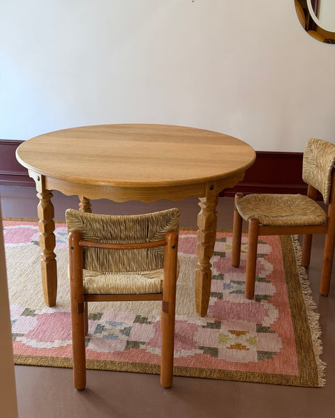 Vintage round wooden dining table with wavy/scalloped details