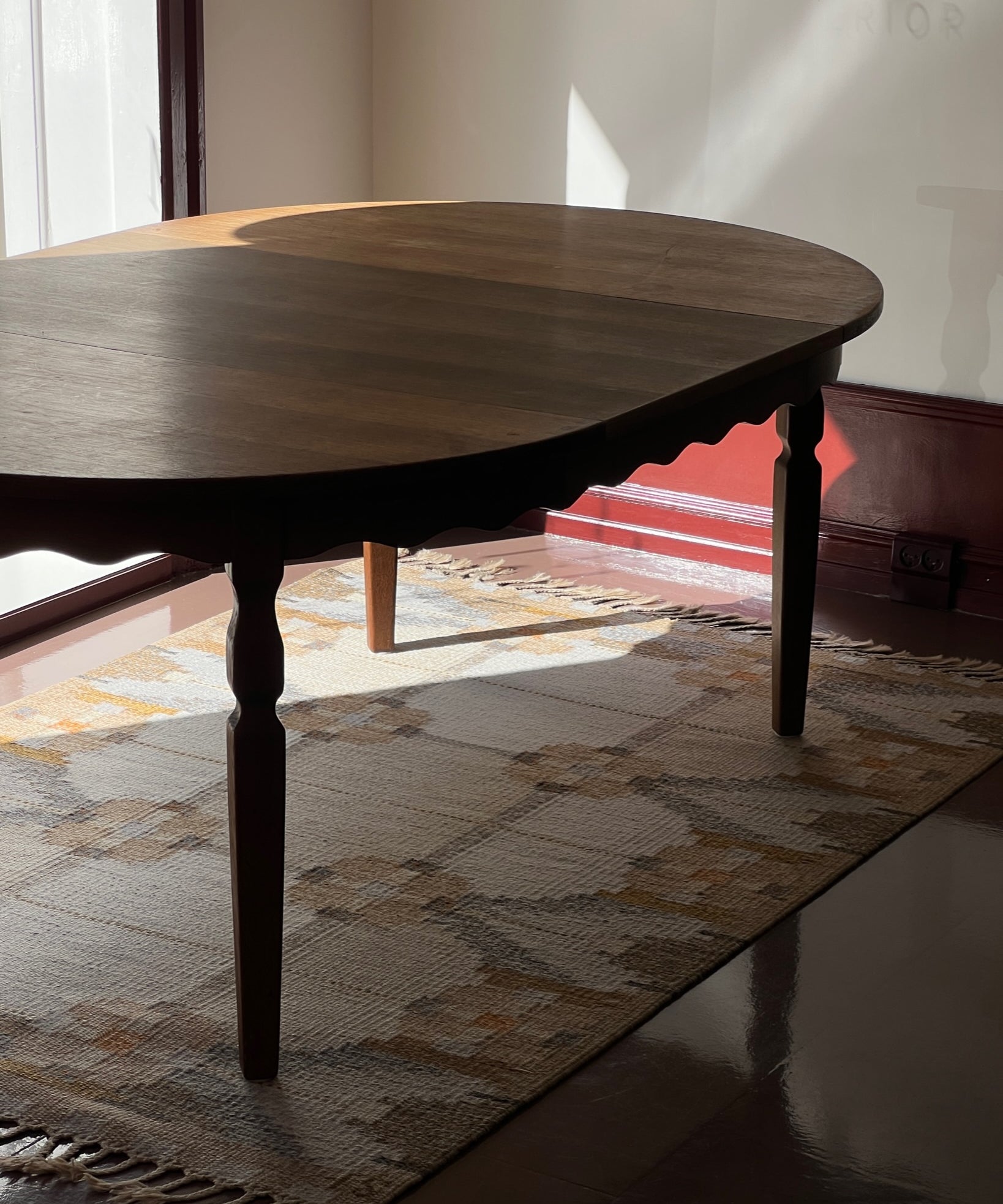 Vintage round wooden dining table with wavy/scalloped details