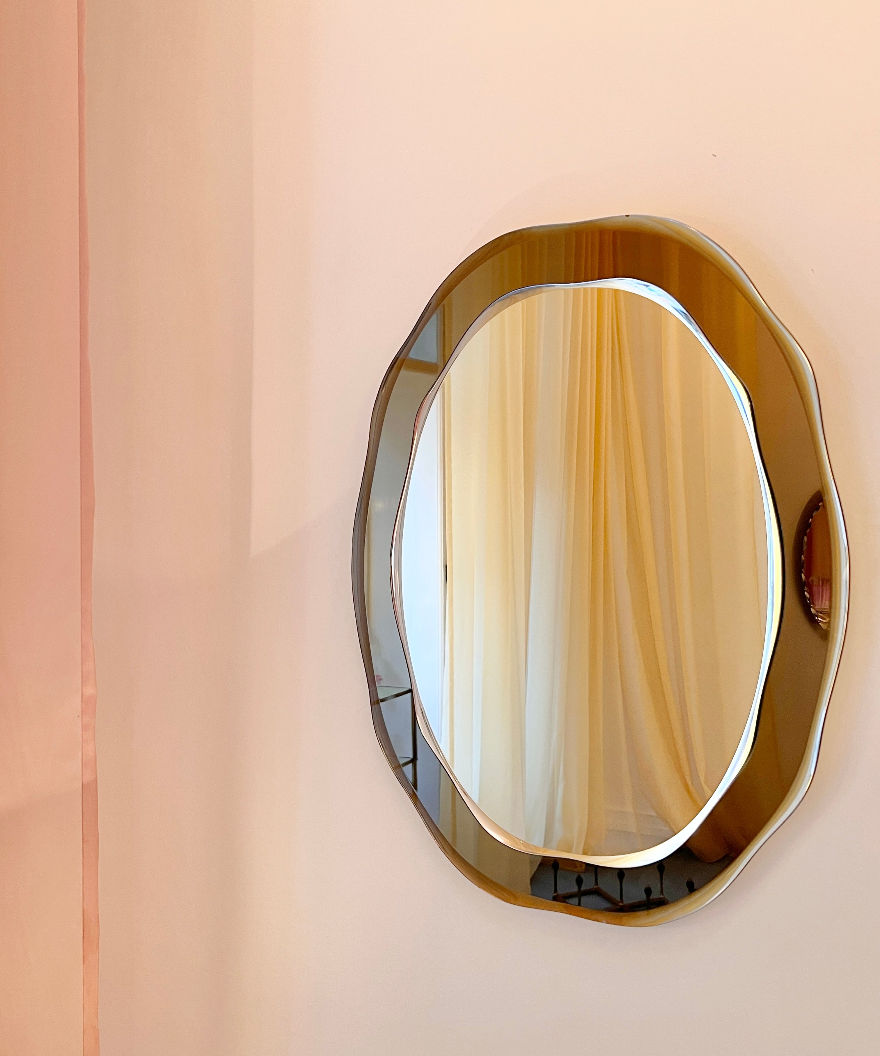 Vintage Italian mirror with wavy golden brown frame